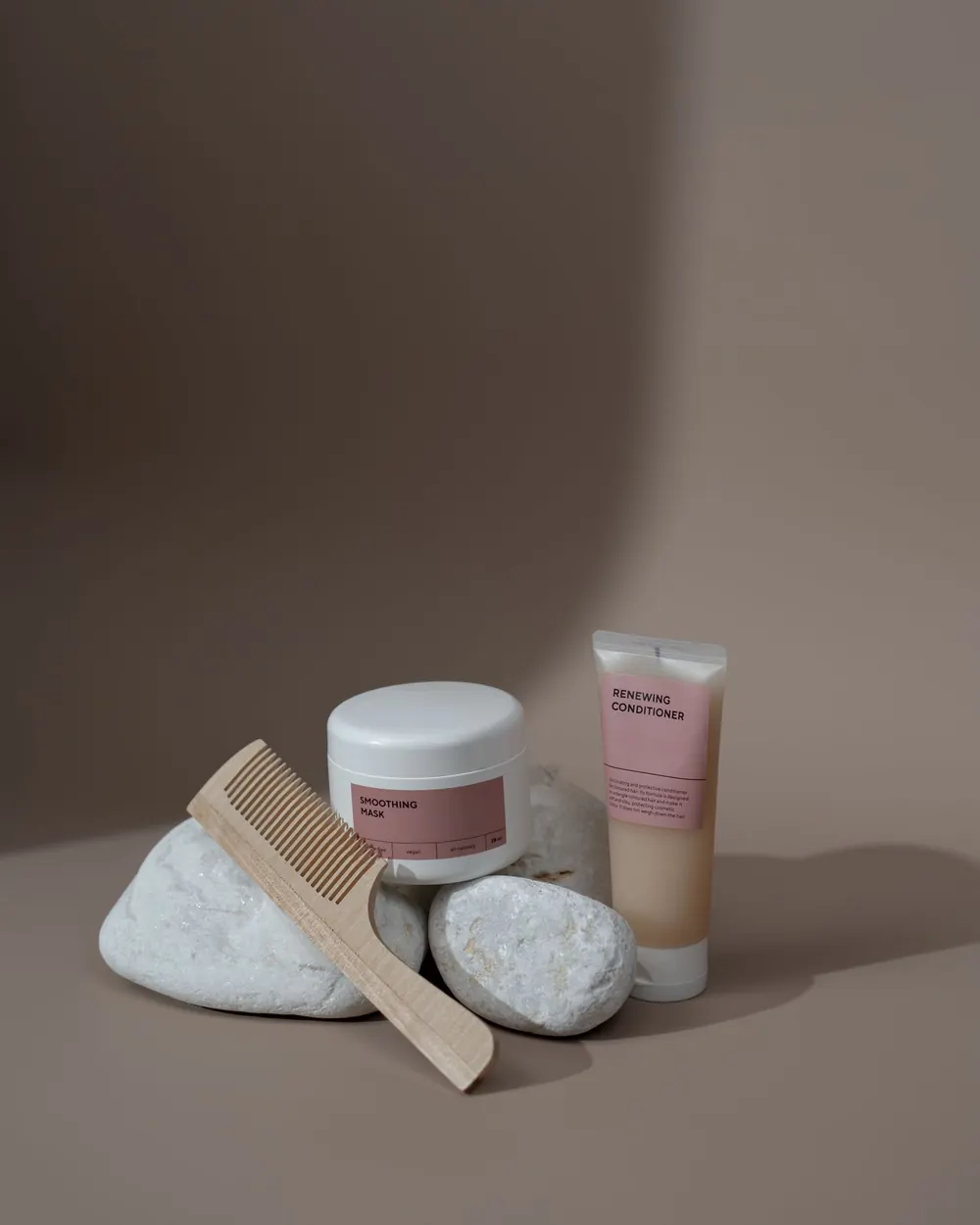 Minimalist composition featuring beauty products and a comb for a serene aesthetic.